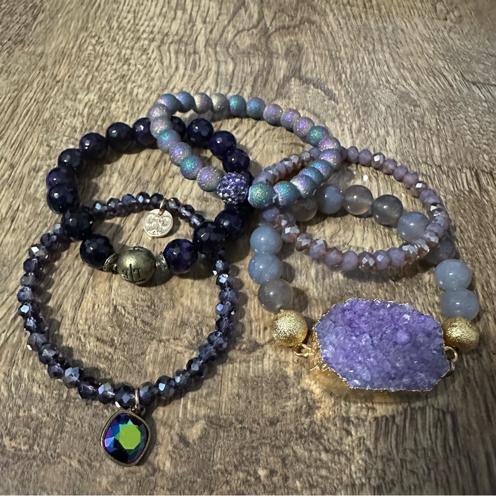 Five stretchy purple bracelets. Excellent condition.